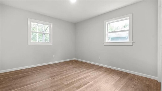 8741 Reeds Rd, Overland Park, KS 66207 - empty room with plenty of natural light, baseboards, and light wood-style flooring