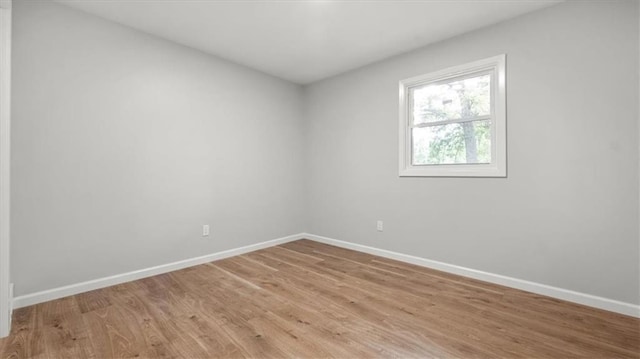 8741 Reeds Rd, Overland Park, KS 66207 - empty room with baseboards and light wood-style flooring