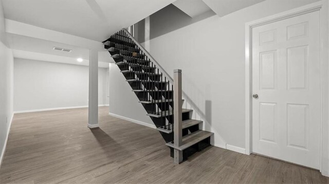8741 Reeds Rd, Overland Park, KS 66207 - staircase with wood finished floors and baseboards