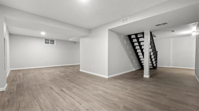 8741 Reeds Rd, Overland Park, KS 66207 - finished basement with stairway, wood finished floors, and baseboards