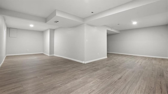 8741 Reeds Rd, Overland Park, KS 66207 - finished below grade area with baseboards, wood finished floors, and recessed lighting