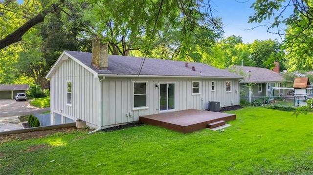8741 Reeds Rd, Overland Park, KS 66207 - back of house featuring board and batten siding, a deck, a chimney, and roof with shingles