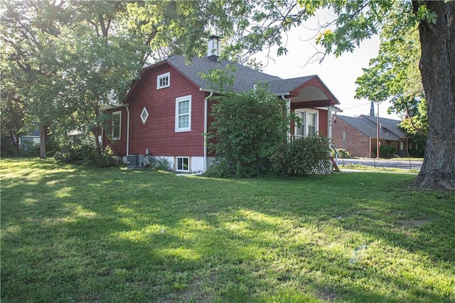 1340 S Osage St, Independence, MO 64055 - view of side of home featuring a yard and cooling unit