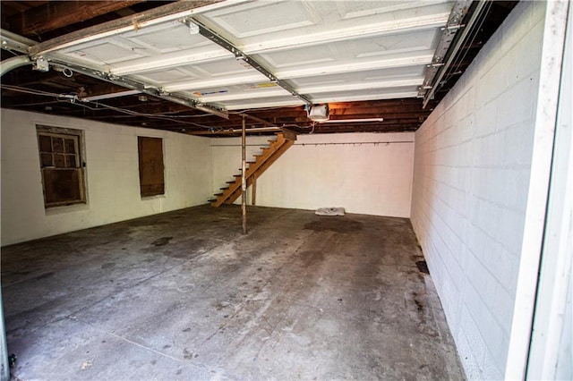 1340 S Osage St, Independence, MO 64055 - garage featuring concrete block wall and a garage door opener