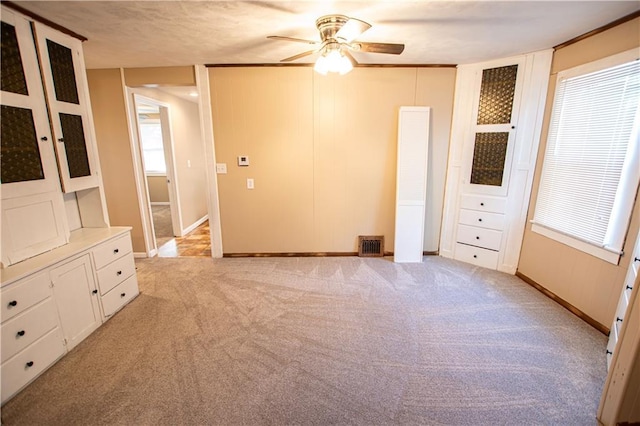 1340 S Osage St, Independence, MO 64055 - unfurnished bedroom with light carpet, baseboards, and ceiling fan