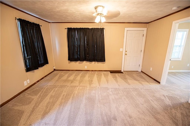 1340 S Osage St, Independence, MO 64055 - carpeted empty room with crown molding, a textured ceiling, a smoke detector, and baseboards