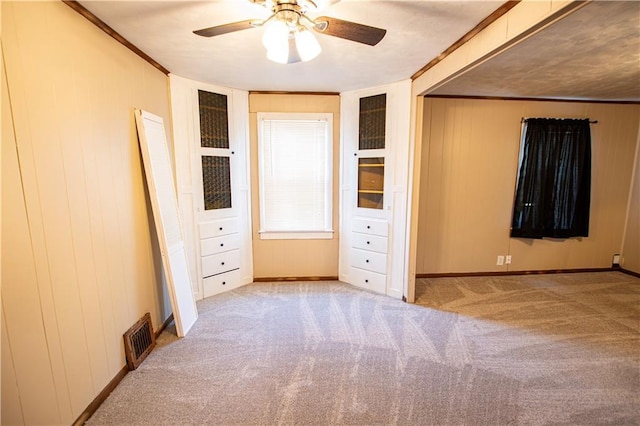 1340 S Osage St, Independence, MO 64055 - unfurnished bedroom featuring carpet, ornamental molding, baseboards, and a ceiling fan