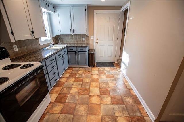 1340 S Osage St, Independence, MO 64055 - kitchen with electric range oven, tasteful backsplash, a sink, baseboards, and gray cabinetry