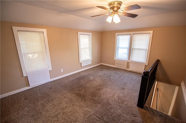1340 S Osage St, Independence, MO 64055 - spare room with dark carpet, ceiling fan, baseboards, and lofted ceiling
