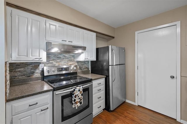 470 W 104th St Unit C, Kansas City, MO 64114 - kitchen with under cabinet range hood, appliances with stainless steel finishes, wood finished floors, and white cabinets
