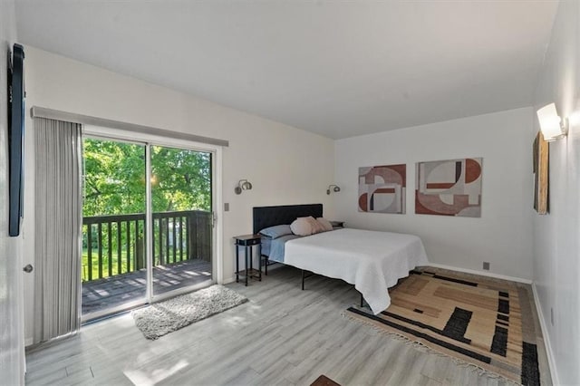 470 W 104th St Unit C, Kansas City, MO 64114 - bedroom with access to exterior, baseboards, and wood finished floors