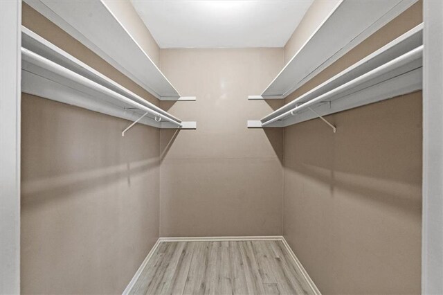 470 W 104th St Unit C, Kansas City, MO 64114 - walk in closet featuring wood finished floors