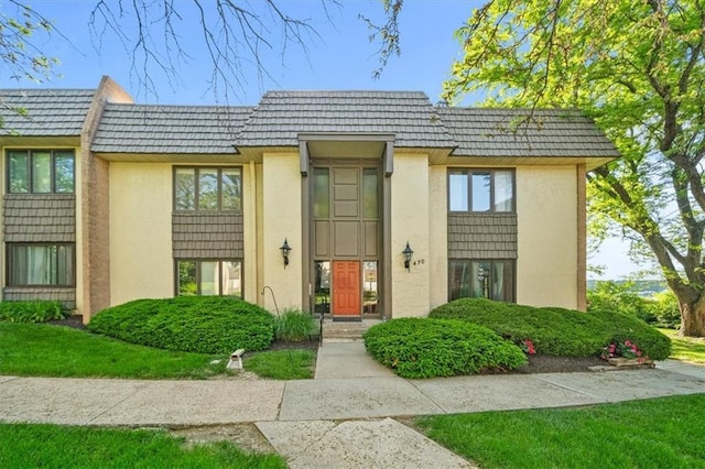 470 W 104th St Unit C, Kansas City, MO 64114 - view of front of home featuring mansard roof and stucco siding