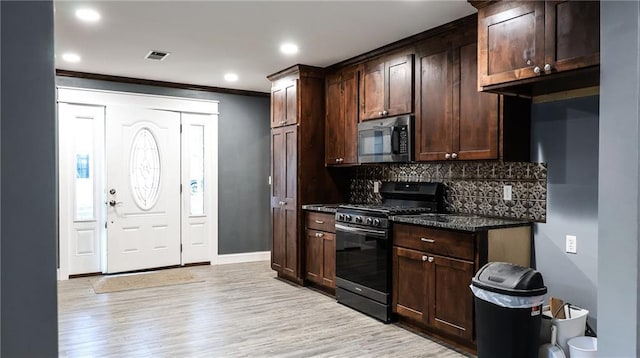 240 W 3rd Ave, Garnett, KS 66032 - kitchen with stainless steel appliances, decorative backsplash, dark brown cabinetry, light wood-type flooring, and crown molding
