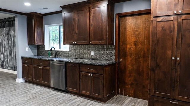 240 W 3rd Ave, Garnett, KS 66032 - kitchen with stainless steel dishwasher, baseboards, decorative backsplash, light wood-style flooring, and a sink