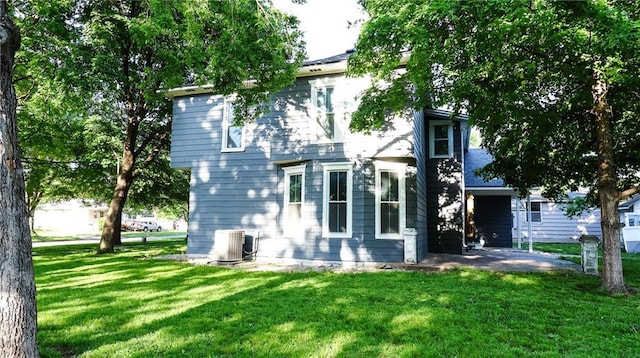 240 W 3rd Ave, Garnett, KS 66032 - rear view of property featuring a yard and central air condition unit
