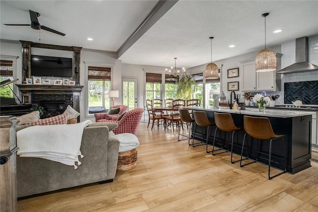 11809 E Ridgeview Ct, Peculiar, MO 64078 - living area with a fireplace, ceiling fan, light wood-style flooring, healthy amount of natural light, and recessed lighting