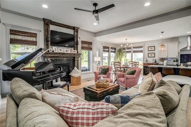 11809 E Ridgeview Ct, Peculiar, MO 64078 - living room featuring light wood-style floors, a ceiling fan, ornamental molding, recessed lighting, and a fireplace