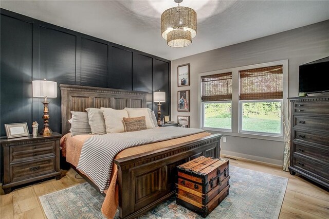 11809 E Ridgeview Ct, Peculiar, MO 64078 - bedroom with a chandelier, light wood-style floors, and baseboards