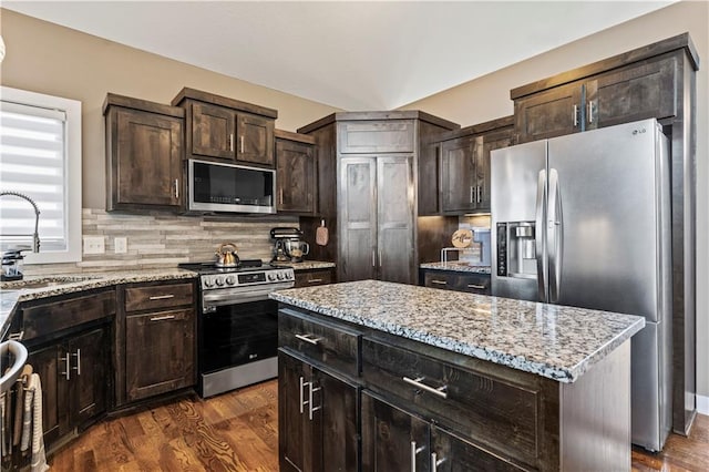4108 NW 76th St, Kansas City, MO 64151 - kitchen with stainless steel appliances, a sink, dark wood-type flooring, and dark brown cabinetry