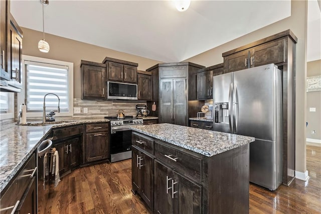 4108 NW 76th St, Kansas City, MO 64151 - kitchen with stainless steel appliances, a sink, dark wood-style flooring, decorative backsplash, and dark brown cabinets