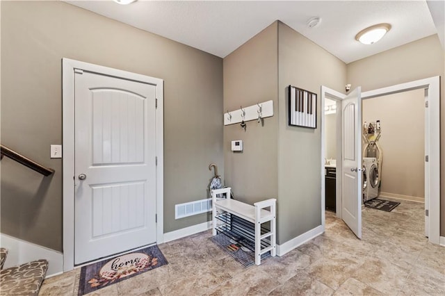 4108 NW 76th St, Kansas City, MO 64151 - foyer entrance with washer and clothes dryer and baseboards