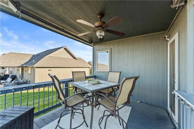 4108 NW 76th St, Kansas City, MO 64151 - wooden deck featuring outdoor dining area, a ceiling fan, and a lawn
