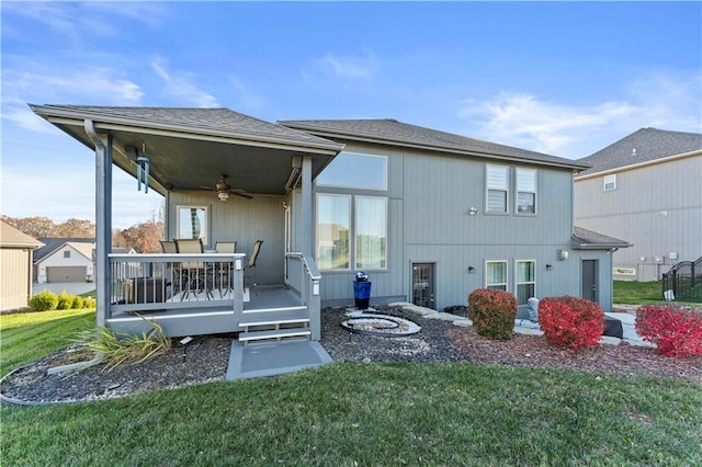 4108 NW 76th St, Kansas City, MO 64151 - back of house with ceiling fan, a yard, and a wooden deck