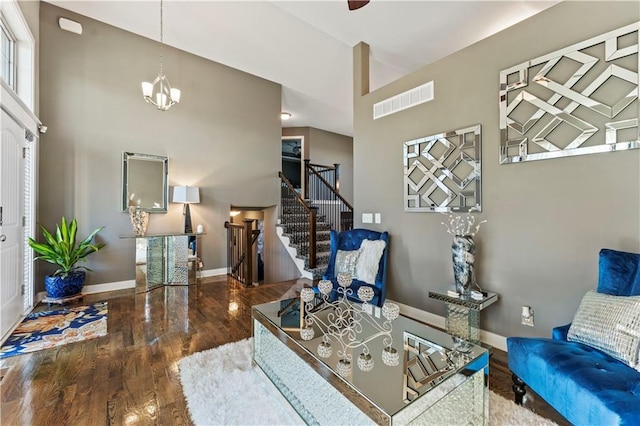 4108 NW 76th St, Kansas City, MO 64151 - living area with stairway, wood finished floors, baseboards, and a towering ceiling