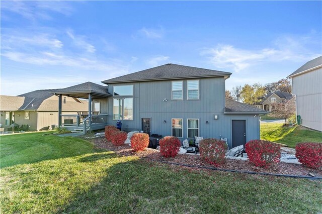 4108 NW 76th St, Kansas City, MO 64151 - rear view of property with a yard and a shingled roof