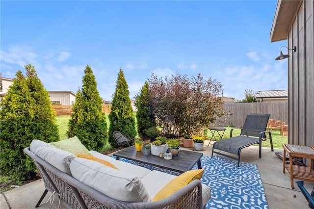 view of patio featuring an outdoor living space and a fenced backyard