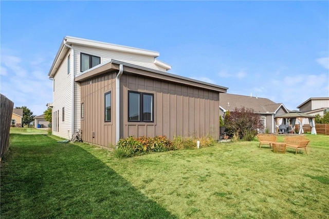 view of home's exterior featuring a lawn and board and batten siding