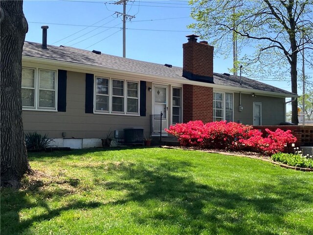 5912 Longview Rd, Kansas City, MO 64134 - single story home with a chimney and a front lawn