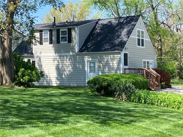 5912 Longview Rd, Kansas City, MO 64134 - view of side of property with a shingled roof and a yard