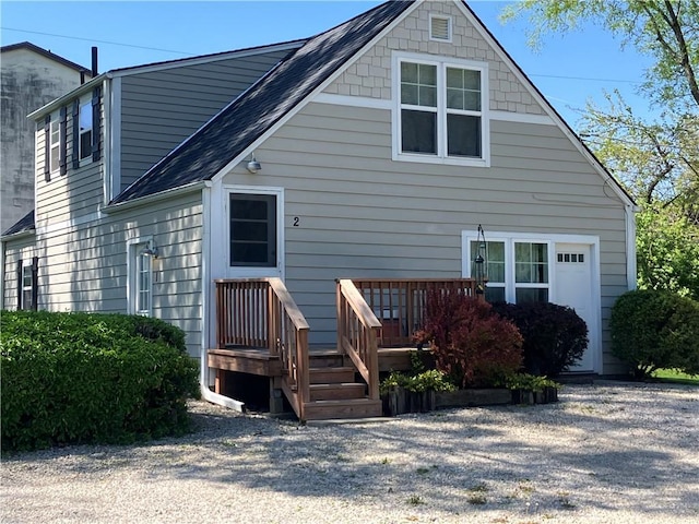 5912 Longview Rd, Kansas City, MO 64134 - back of property featuring roof with shingles and a deck