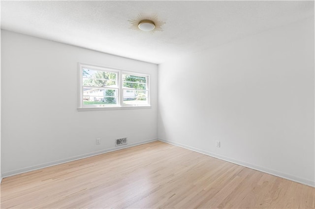 218 NW 43rd Ter, Kansas City, MO 64116 - spare room with light wood-style floors and baseboards