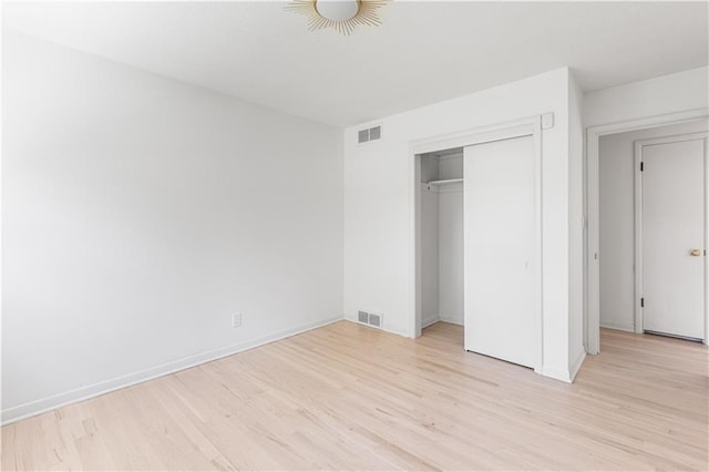 218 NW 43rd Ter, Kansas City, MO 64116 - unfurnished bedroom with light wood-type flooring, a closet, and baseboards