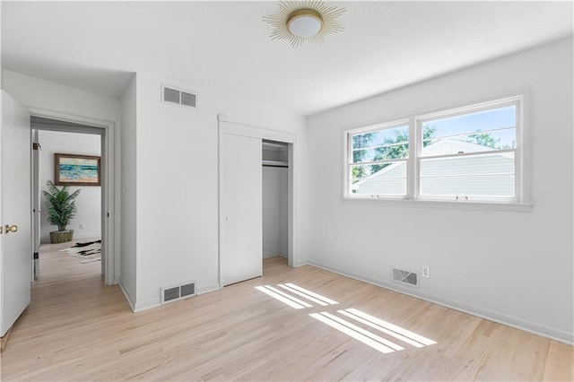 218 NW 43rd Ter, Kansas City, MO 64116 - unfurnished bedroom featuring light wood-style floors, a closet, and baseboards