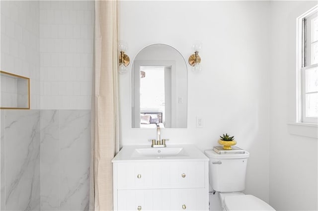 218 NW 43rd Ter, Kansas City, MO 64116 - full bath featuring toilet, a marble finish shower, and vanity