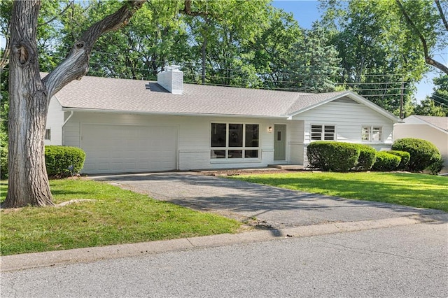 218 NW 43rd Ter, Kansas City, MO 64116 - ranch-style home with a garage, asphalt driveway, a chimney, a front yard, and brick siding
