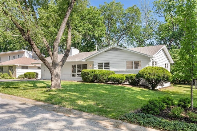 218 NW 43rd Ter, Kansas City, MO 64116 - view of front of home featuring a chimney and a front yard