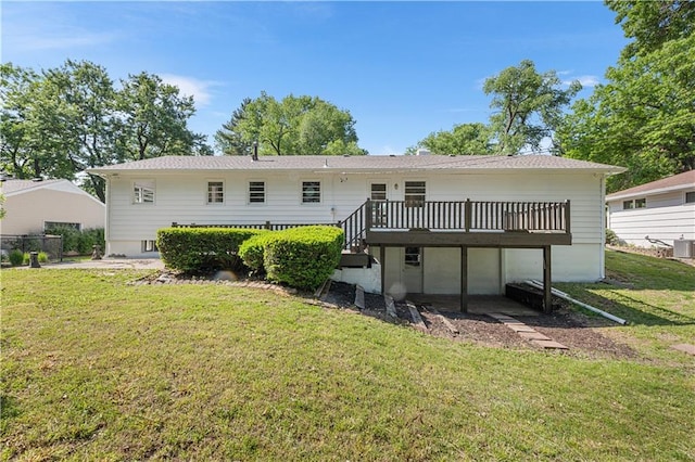 218 NW 43rd Ter, Kansas City, MO 64116 - back of house with a deck and a lawn