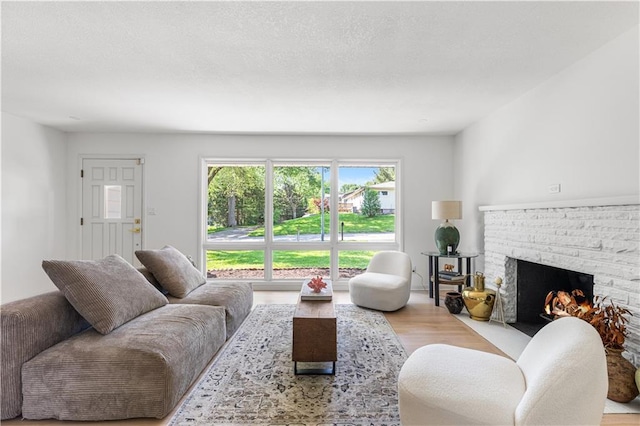 218 NW 43rd Ter, Kansas City, MO 64116 - living room with wood finished floors and a warm lit fireplace