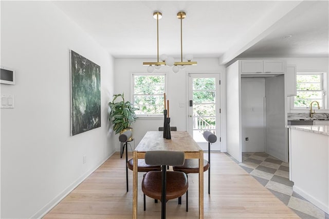 218 NW 43rd Ter, Kansas City, MO 64116 - dining room featuring a chandelier and light wood-style floors
