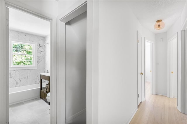 218 NW 43rd Ter, Kansas City, MO 64116 - hallway featuring baseboards and a textured ceiling