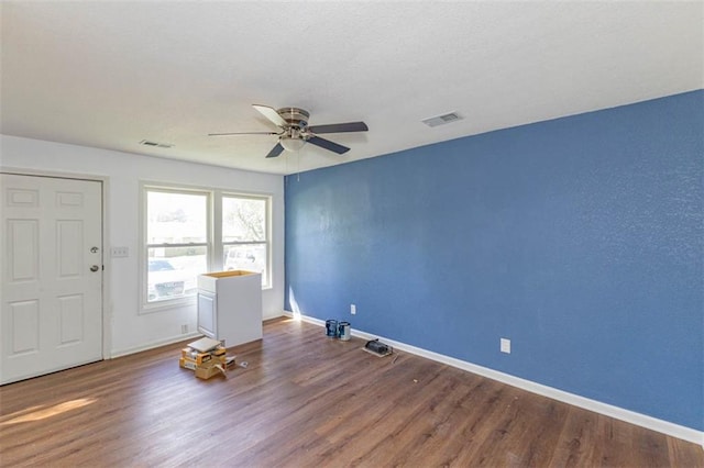 6021 E 151st Ter, Grandview, MO 64030 - unfurnished room with ceiling fan, wood finished floors, and baseboards