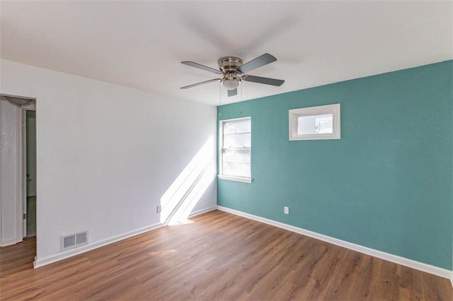 6021 E 151st Ter, Grandview, MO 64030 - unfurnished room featuring wood finished floors, ceiling fan, and baseboards