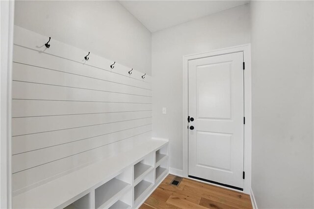 mudroom featuring light wood-style floors and baseboards