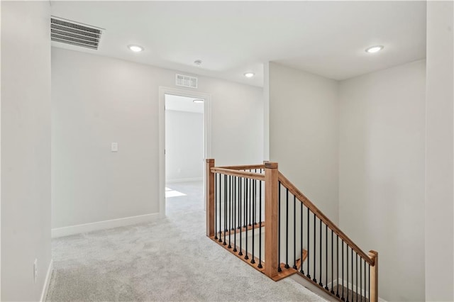 corridor featuring an upstairs landing, carpet floors, recessed lighting, and baseboards