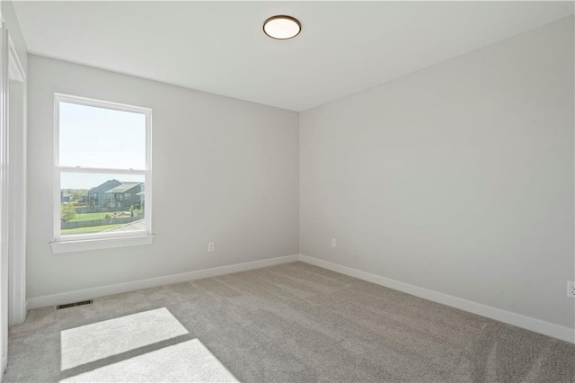 empty room with light carpet and baseboards